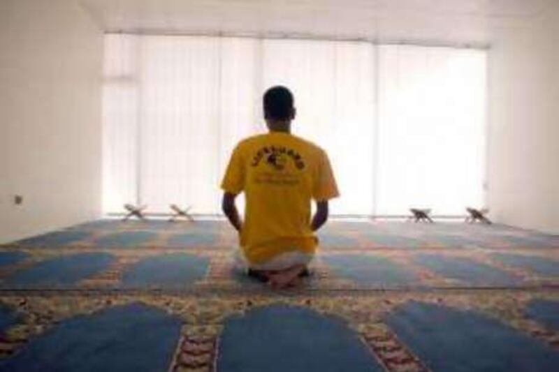 The lifeguard Khaled Sherbini prays in a mosque near the beach in Abu Dhabi.