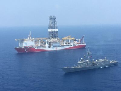 A handout photograph taken and relased by the Turkish Defence Ministery on July 9,2019 shows a Turkish Navy warship patroling next to Turkey's drilling ship "Fatih" dispatched towards the eastern Mediterranean near Cyprus. - Turkey will "increase" its activities off Cyprus after the EU approved measures to punish Ankara for drilling operations in the eastern Mediterranean, the Turkish foreign minister said on July 16, 2019. (Photo by DEFENCE MINISTERY PRESS SERVICE / TURKISH DEFENCE MINISTRY / AFP) / RESTRICTED TO EDITORIAL USE - MANDATORY CREDIT "AFP PHOTO / TURKISH DEFENCE MINISTRY" - NO MARKETING - NO ADVERTISING CAMPAIGNS - DISTRIBUTED AS A SERVICE TO CLIENTS