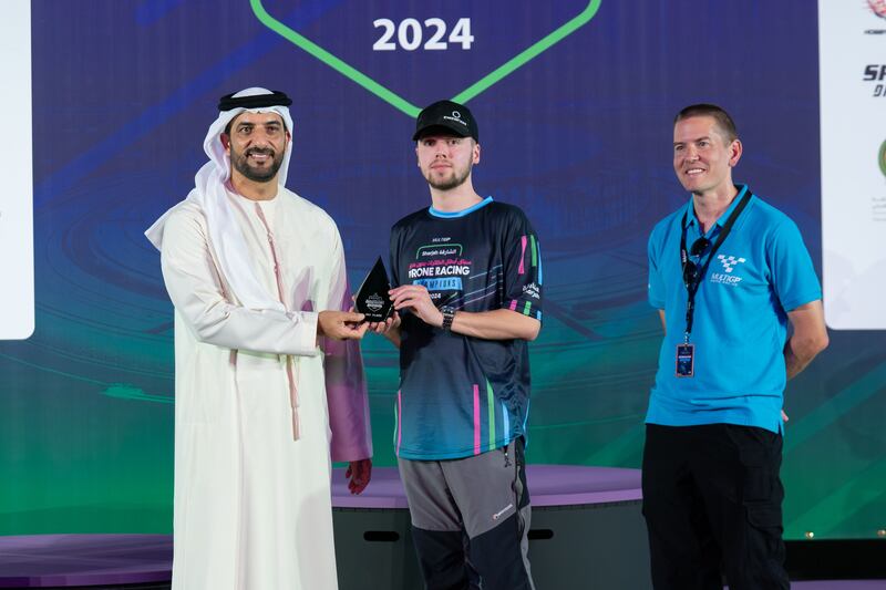 Sheikh Sultan awards the second runner up prize to British racer Luke Bannister, known as Banni UK 