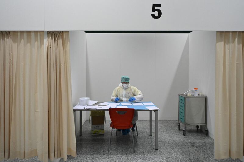 A medical worker works in the test area at Malpensa Airport in Milan, where passengers are set to arrive to undergo a rapid swab test for Covid-19 after disembarking from the first "Covid-tested" and "quarantine-free" flight from New York to northern Italy. AFP