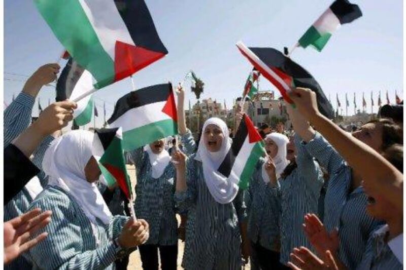 Palestinian school girls in the West Bank city of Ramallah wave flags during a rally against President Barack Obama's address at the UN General Assembly yesterday. Mohamad Torokman / Reuters