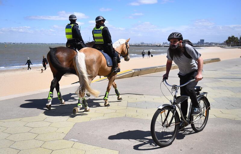 Police patrol on horseback along the St Kilda Esplanade in Melbourne as Australian health officials reported no new coronavirus cases or deaths in Victoria state, which has spent months under onerous restrictions after becoming the epicentre of the country's second wave.  AFP