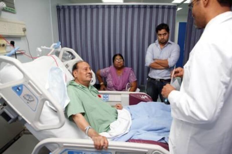 September 27. Patient Aftab Ahmed Shaikh (Pakistani 75) being attended to by Dr Khalifa Omar Muhammed, Senior Specialist in Cardiology at Rashid Hospital. Also with Aftab is his wife, Mumtaz Ahmed Shaikh (63) and son Imran Ahmed Shaikh (33). September 27, Dubai, United Arab Emirates (Photo: Antonie Robertson/The National)