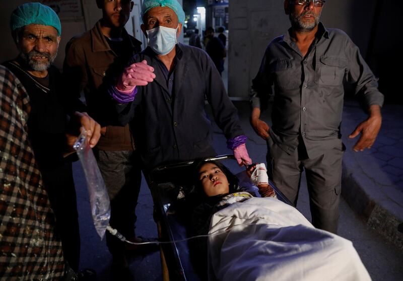 An injured school girl waits for a transport from one hospital to another after a blast in Kabul, Afghanistan. Reuters