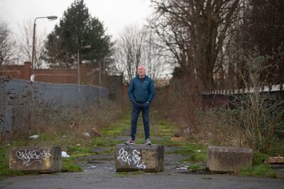 Norman Reilly stands in what remains of the top end of Mountcollyer Street in North Belfast. Photo: Paul McErlane / The National