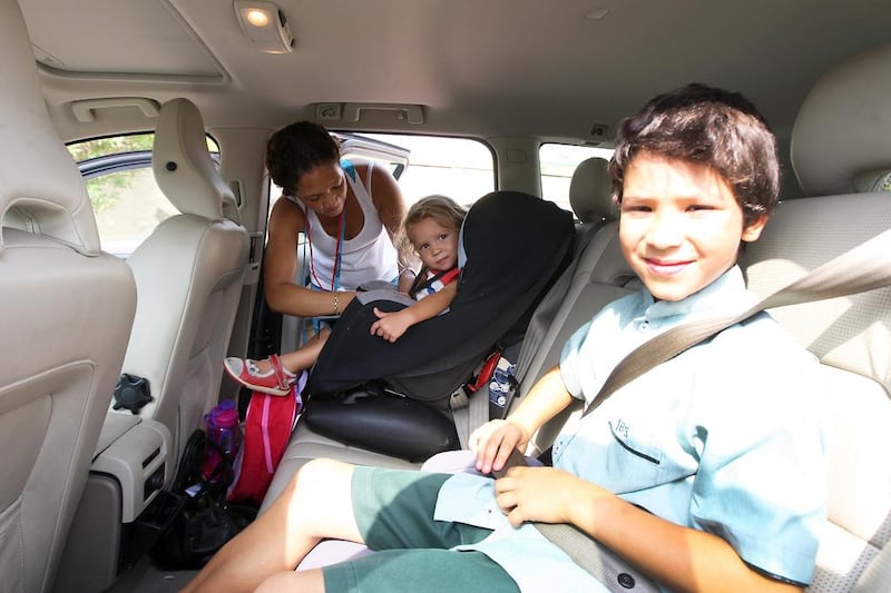 Anthea Modin from South Africa buckles up her daughter, Thalia, 2, and her son, Trond, 8. Pawan Singh / The National