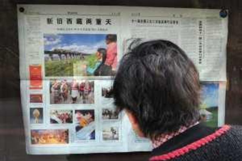 A woman reads a state media newspaper with coverage on the 50th anniversary of Communist China's "liberation" of Tibet taking up a full page on March 7, 2009 at a park in Beijing. Tibet has asked for more police and other security personnel, one of the region's top leaders said on March 6 on the sideline on the ruling party's National People's Congress, expressing fears that the Dalai Lama's supporters could create unrest as exiled Tibetan groups have warned of possible unrest in the region this year to coincide with the 50th anniversaries of an uprising against Chinese rule and the Dalai Lama's exile. China has ruled Tibet since 1951, a year after sending in troops to "liberate" the Buddhist region. AFP PHOTO/ Frederic J. BROWN