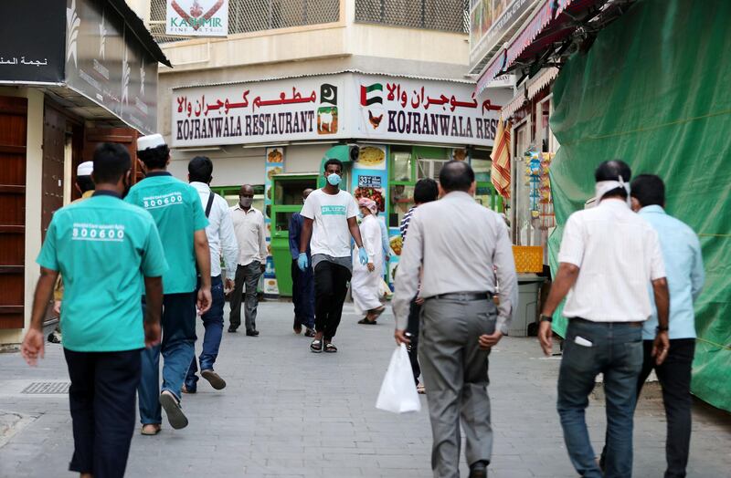 DUBAI, UNITED ARAB EMIRATES , April 27 – 2020 :- People walking on the streets in Al Ras area in Deira Dubai. Authorities ease the restriction for the residents after almost a month long locked down of Al Ras district. (Pawan Singh / The National) For News/Standalone/Online/Instagram