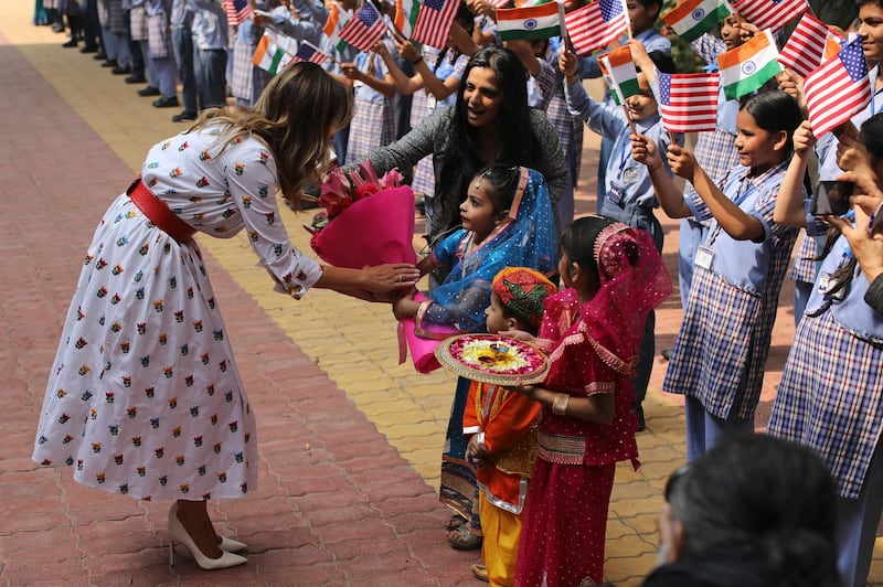 U.S. First Lady Melania Trump receives a bouquet of flowers from children at Sarvodaya Co-Educational Senior Secondary School in New Delhi, India.  AP