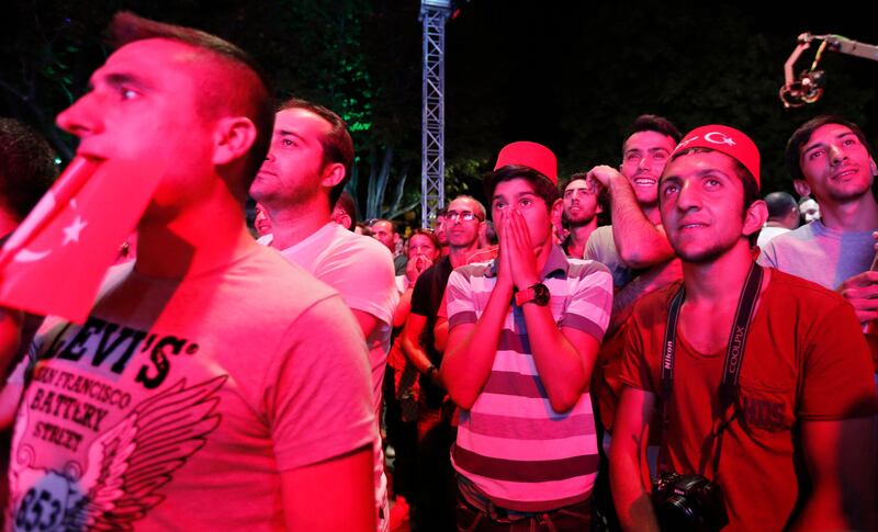 Turks react after finding out that Tokyo was awarded the right to host the 2020 Summer Games as they watch it live on big screens in Sultanahmet Square in Istanbul September 7, 2013.  REUTERS/Murad Sezer (TURKEY - Tags: SPORT OLYMPICS) *** Local Caption ***  IST02_OLYMPICS-2020_0907_11.JPG