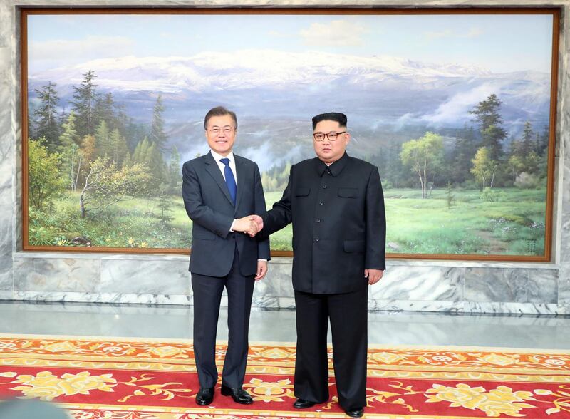 This picture taken on May 26, 2018 and released by the Blue House via Dong-A Ilbo shows South Korea's President Moon Jae-in (L) shaking hands with North Korea's leader Kim Jong Un before their second summit at the north side of the truce village of Panmunjom in the Demilitarized Zone (DMZ). South Korea said President Moon Jae-in met with North Korea's leader Kim Jong Un on May 26 inside the Demilitarised Zone dividing the two nations, a day after US President Donald Trump threatened to abandon a summit with Pyongyang. - South Korea OUT
 / AFP / Dong-A Ilbo / Handout
