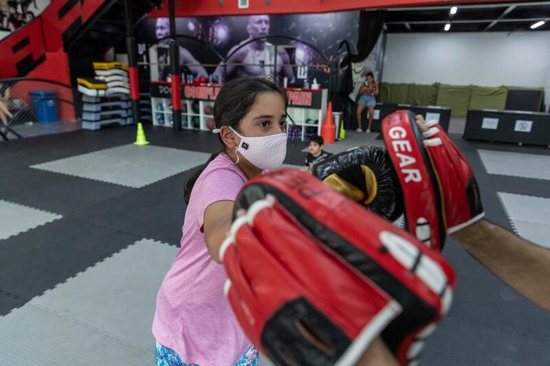 Children are receiving boxing lessons from coach David Fifita at Ringside gym in Dubai. All photos by Antonie Robertson / The National