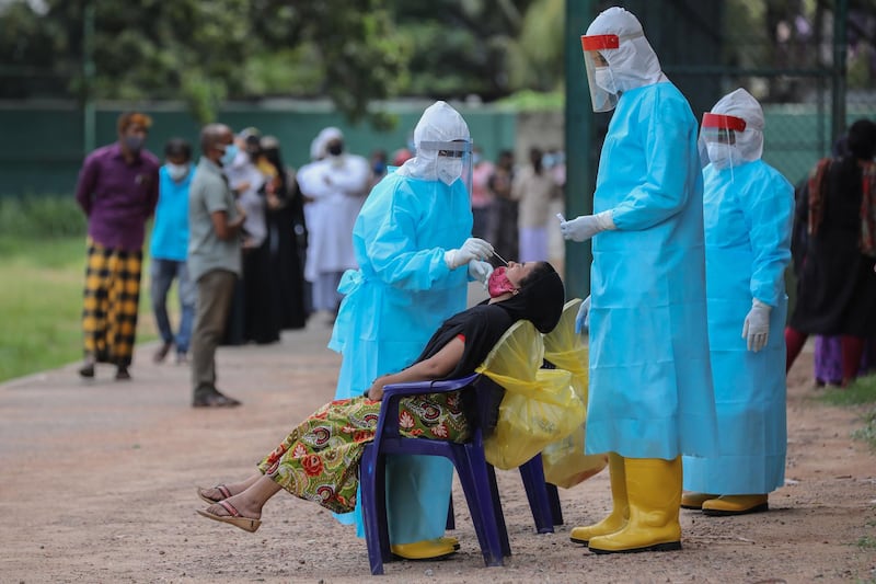 People undergo swab tests at an area under lockdown amid the coronavirus pandemic in Colombo, Sri Lanka.   EPA
