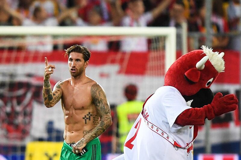 Ramos celebrates post match, although the Salzburg mascot does not look too happy. EPA