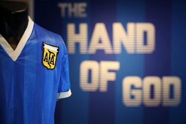 (FILES) In this file photo taken on April 20, 2022 a football shirt worn by Argentina's Diego Maradona during the 1986 World Cup quarter-final match against England, is pictured during a photocall at Sotheby's auction house in London ahead of its sale.  - The jersey that Argentina football legend Diego Maradona wore when scoring twice against England in the 1986 World Cup, including the infamous "hand of God" goal, was auctioned for $9. 3 million, a record for any item of sports memorabilia, Sotheby's said May 4, 2022.  (Photo by ADRIAN DENNIS  /  AFP)