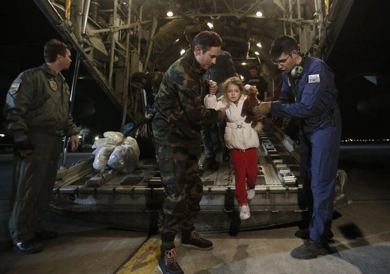 Rescued passengers of the "Norman Atlantic" accident, Marko Gondolo, second left, 40, and his daughter Serafina, 5, arrive from Italy at Elefsina Air Base outside Athens. About 43 passengers from the Norman Atlantic arrived in the Greek capital as the death toll climbed to 10. Yannis Kolesidis / AP