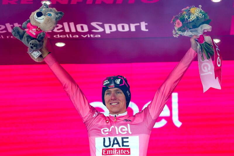 UAE Team Emirates rider Tadej Pogacar celebrates on the podium after Stage 17 of the Giro d'Italia on May 22, 2024. AFP