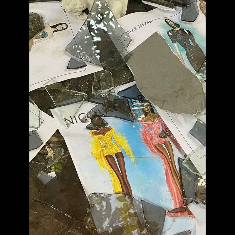 Sketches of Nicolas Jebran's designs for Cardi B and Megan Thee Stallion can be seen among broken glass and debris in the designer's Beirut atelier. Instagram / Nicolas Jebran