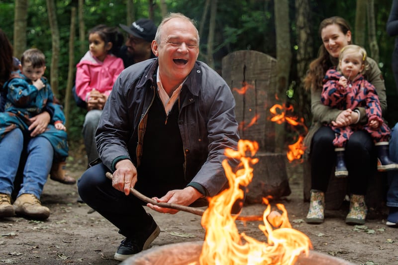 Liberal Democrat Party leader Ed Davey toasts a marshmallow as he visits Willow Forest School in Surrey. EPA