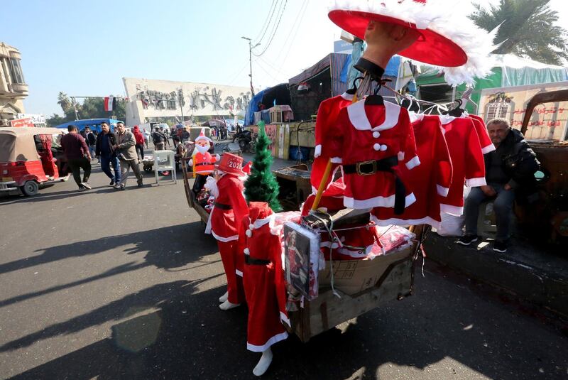 Christmas outfits hang for sale at an Iraqi anti-government camp site in Baghdad's Tahrir square. AFP