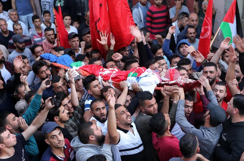 epa07988898 Palestinians carry the body of Palestinian Omar Badawi during his funeral in the Aroub refugee camp, north of the West Bank city of Hebron, 11 November 2019. According to reprts, the 22-year-old Palestinian was shot during clashes with Israeli forces in Aroub refugee camp as Palestinians were throwing stones at Israeli troops during the 15th death anniversary of former president Yasser Arafat.  EPA/ABED AL HASHLAMOUN