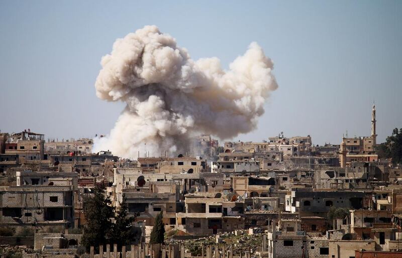 Smoke billows following a reported air strike on a rebel position in the Syrian city of Deraa on February 20, 2017 during clashes between opposition fighters and pro-government forces. Mohamad Abazeed / AFP

