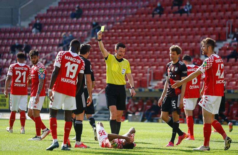 Bayern Munich's forward Robert Lewandowski is shown a yellow card by referee Harm Osmers. AFP