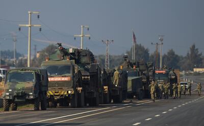 FILE - In this Feb. 14, 2020, file photo, Turkish troops and artillery prepare to enter Syria, in Reyhanli, Hatay, Turkey. Syriaâ€™s civil war has long provided a free-for-all battlefield for proxy fighters. But in its ninth year, the war is drawing major foreign actors into direct conflict, with the threat of all-out confrontations becoming a real possibility. (AP Photo, File)