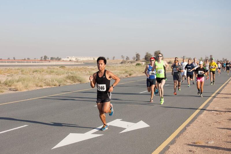 Participants run through the desert from the starting point of the Sevens Stadium during the Dubai Desert Road Run. There are multiple Desert Road Runs throughout the year with the intention of runners being able to track their progress throughout the year. Clint McLean for The National