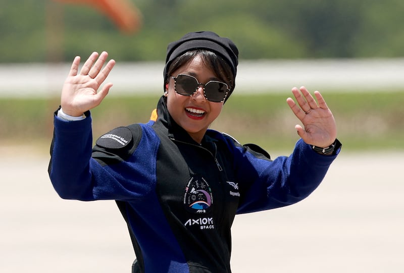 Saudi astronaut Rayyanah Barnawi, a scientific researcher, waves before being brought to the SpaceX Falcon 9 rocket in Florida on Sunday. Getty