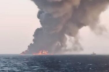 A handout picture made available by the Iranian state TV (IRIB) website shows smoke rising from the largest Iranian navy support ship 'Kharg' in the Gulf of Oman. EPA