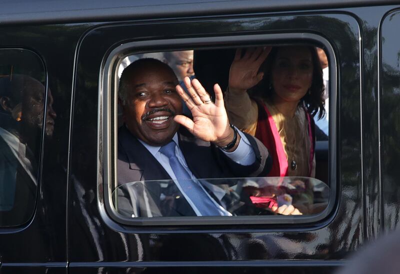 (FILES) In this file photo taken on March 23, 2019 Gabonese President Ali Bongo Ondimba waves from his car upon his arrival in Libreville. Six months after his stroke, and one month after a "final" return to the country late March, President Ali Bongo Ondimba remains invisible in Libreville. / AFP / Steve JORDAN
