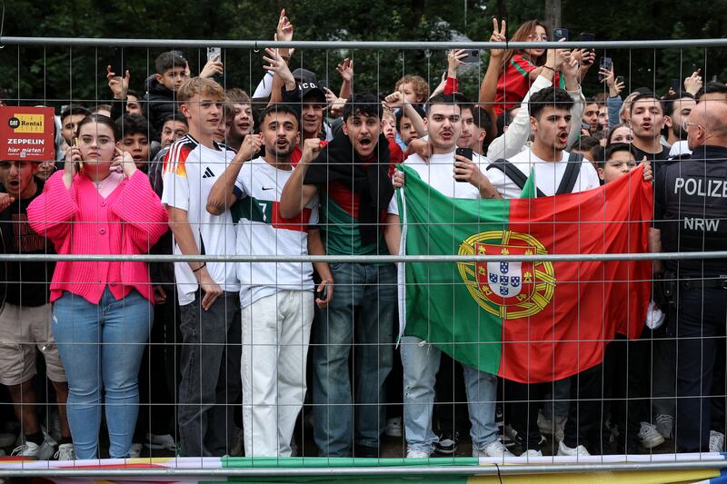 Portugal fans cheer as their national team arrives at Harsewinkel, in north-west Germany. EPA