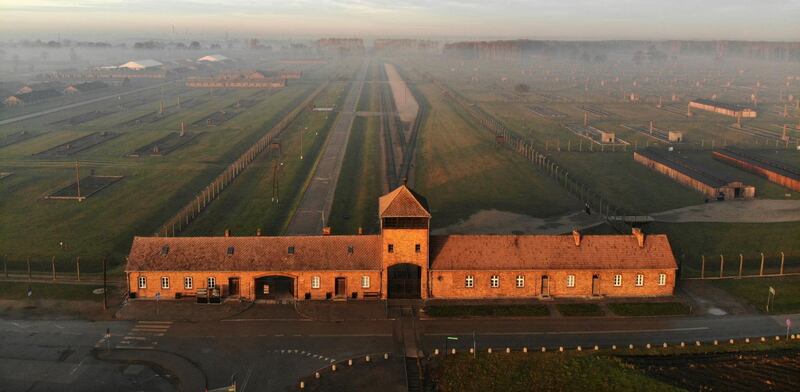 The railway entrance to former German Nazi death camp Auschwitz II - Birkenau with its SS guards tower.  AFP