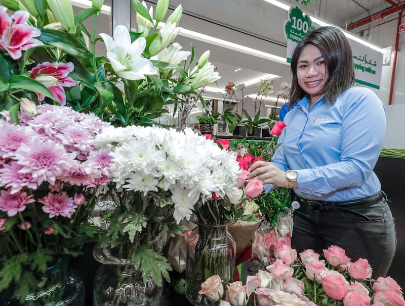 Abu Dhabi, April 24, 2019.Majid Al Futtaim is set to welcome visitors to My City Centre Masdar, its first ever lifestyle destination in the capital, on April 24.  The opening of the mall will be the company’s 25th shopping mall operating in the region. —  A Carrefour florist arranges her flower stand.
Victor Besa/The National 
Section: WK
Reporter:  Sophie Prideaux