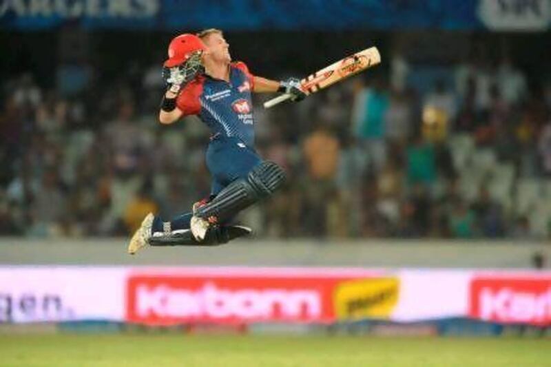 Delhi's David Warner leaps in to air after scoring his century against the Deccan Chargers last night. Noah Saleen / AFP