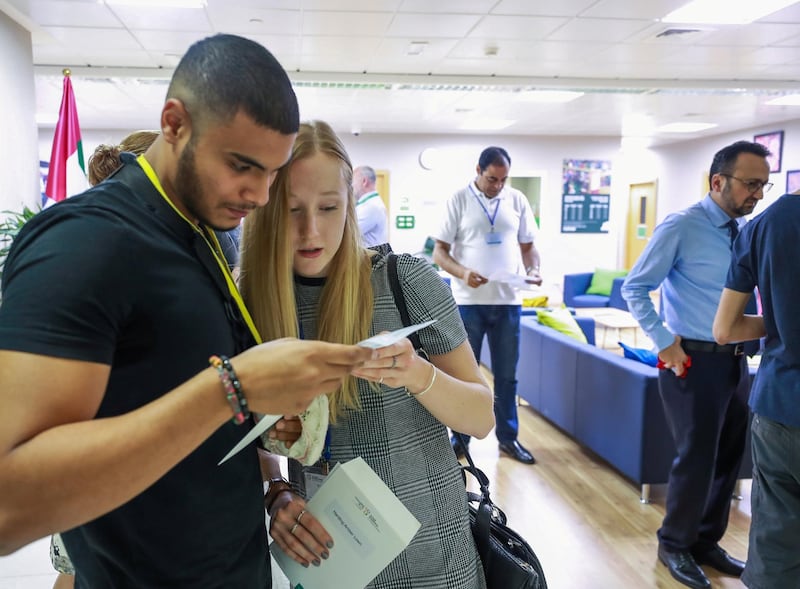 Abu Dhabi, U.A.E., August 16 , 2018. Pupils receiving their A level results at Al Yasmina Academy.  Ahmed Tenaiji and Amber Harding check out the scores of the A level test.
Victor Besa / The National
Section:  NA
Reporter:  Anam Rizvi