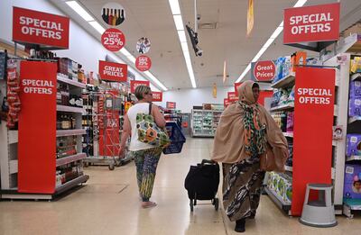 Shoppers at a supermarket in London. Discounting and price freezes are the main weapons in the supermarket price war. EPA