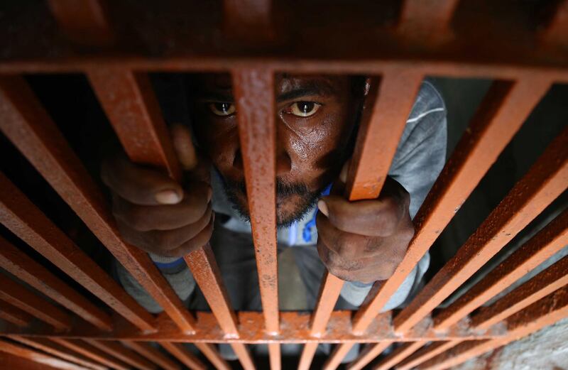 An Indian fishermen who was arrested after allegedly straying into Pakistan's territorial waters, sits behind bars at a police station in Karachi, Pakistan. EPA
