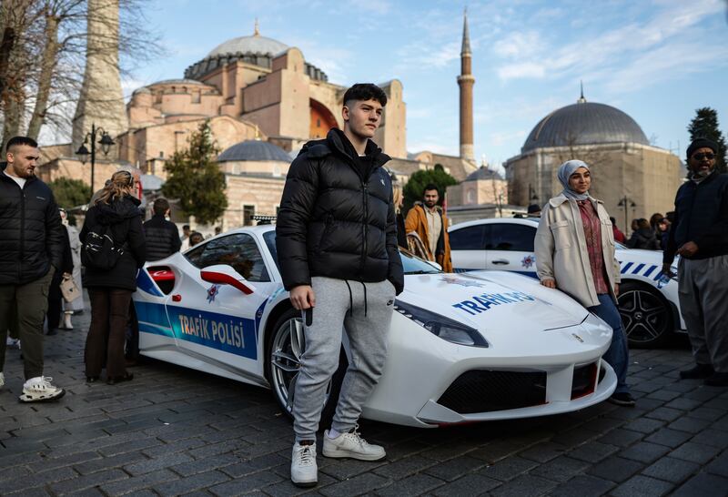 People take a picture with the luxury Ferrari 488 GTB police car in front of the Hagia Sophia in Istanbul, Turkey. EPA 