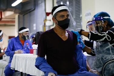 A man receives a Sinopharm Covid-19 vaccine at GuruNanak Darbar in Dubai in February. The Sikh temple opened its doors to offer immunisation to adults of all faiths, free of charge. EPA