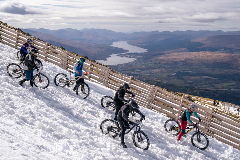Cyclists take part in MacAvalanche, a mountain bike race through the snow, descending more than 900 metres from the summit of Aonach Mor in Scotland. PA