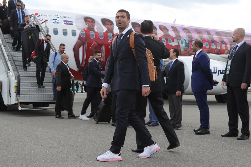 Egyptian national team football player Ahmed Fathi arrives at Grozny International Airport  rocking a leather backpack with two-tone sneakers and a formal suit. Confident. AFP