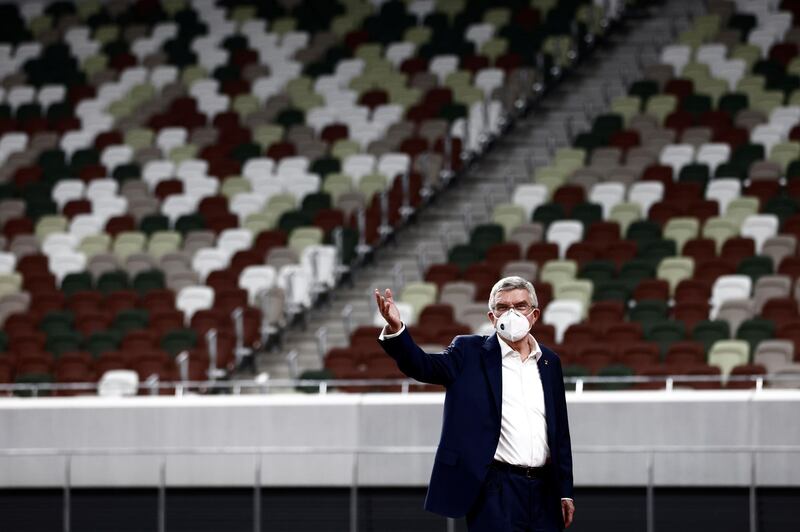 Thomas Bach wears a protective mask as he visits the National Stadium. Reuters