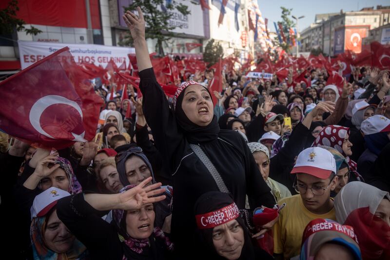 Supporters chant slogans and wave flags as they listen to Turkish President Recep Tayyip Erdogan at a campaign rally in Istanbul. Getty