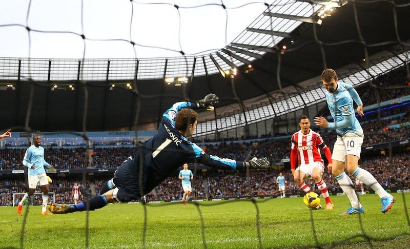 Edin Dzeko, right, of Manchester City misses a close range shot on goal as Stoke City keeper Asmir Begovic looks on during their Premier League match at the Etihad Stadium on February 22, 2014. Clive Brunskill/Getty Images