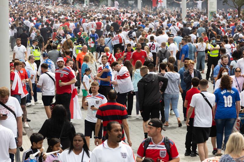 Fans arrive at Wembley stadium ahead of the Euros football final between England and Italy.