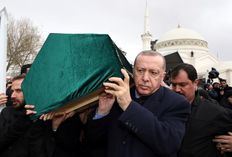 Turkey's President Recep Tayyip Erdogan, center, carries a coffin as he joins hundreds of mourners who attend the funeral prayers for nine members of Alemdar family killed in a collapsed apartment building, in Istanbul, Saturday, Feb. 9, 2019. Erdogan says there are "many lessons to learn" from the collapse of a residential building in Istanbul where at least 17 people have died.(Presidential Press Service via AP, Pool)