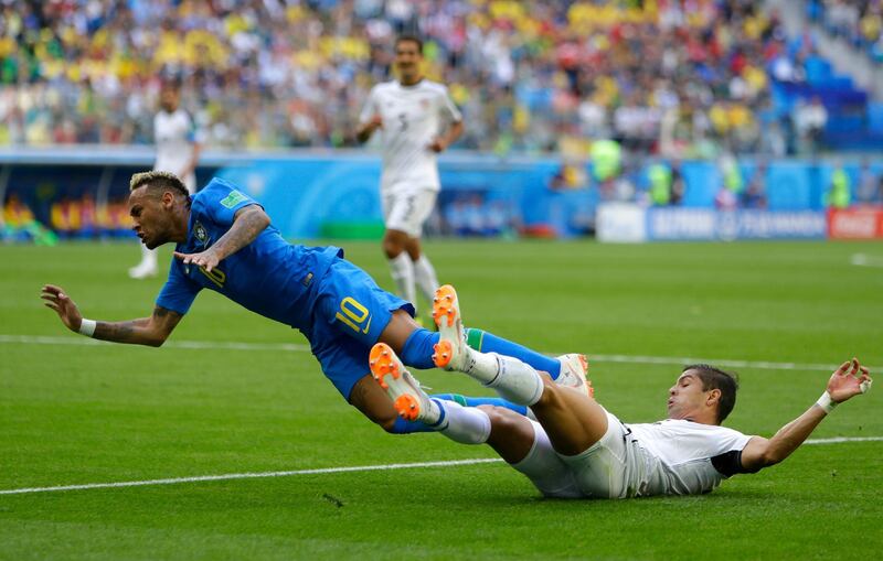 Neymar is tackled by Costa Rica's Cristian Gamboa. Alastair Grant / AP Photo