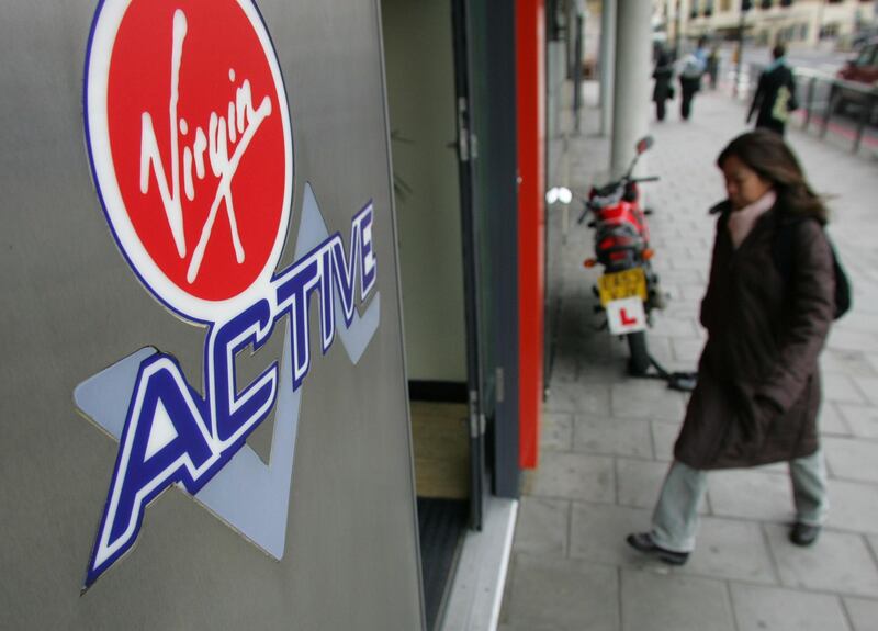 A woman enters a Virgin Active sports facility in London, Tuesday, March 21, 2006. Virgin Group Ltd. is considering acquiring Bally Total Fitness Holding Corp. to expand its British health club operations to the U.S., the New York Post reported, citing unidentified people. Photographer: Suzanne Plunkett/Bloomberg News